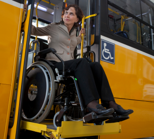 woman in wheelchair getting off bus